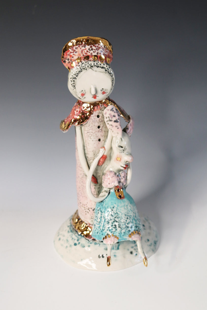 Decorative ceramic figure with a pastel color scheme on a gradient background