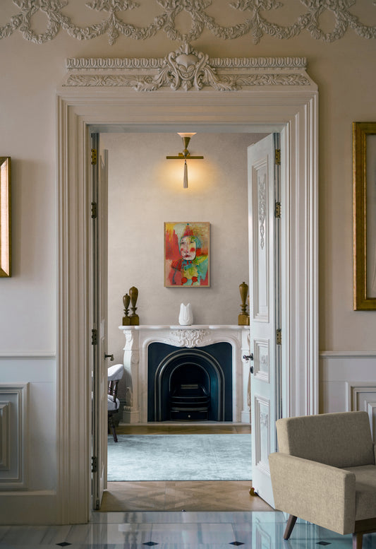 Decorative interior with a fireplace, artwork, and furniture.